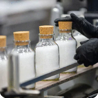 Multiple glass bottles with cork seal containing salt