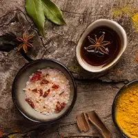 A trio of serving spoons with different spices on each spoon