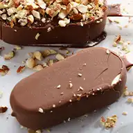 An array of ice cream bars with assorted chocolate coatings, some milk, some white and some flavoured or topped with nuts