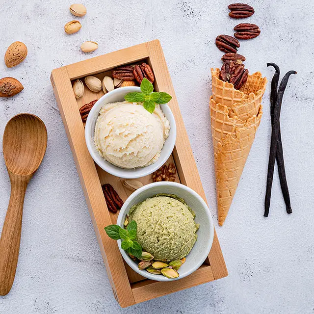 Above shot of two ice cream flavors with a cone  and other garnish on the side