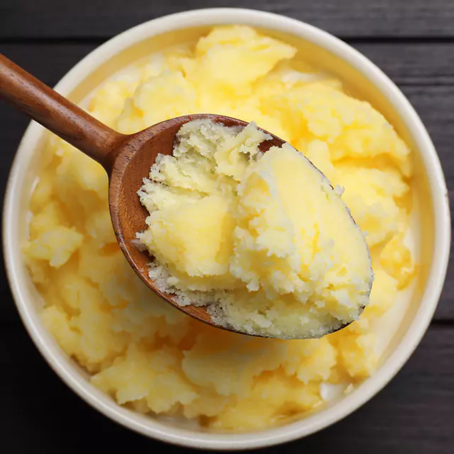 Close up shot of softened butter on a spoon