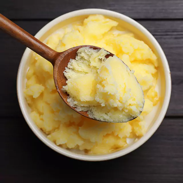 Close up shot of a spoonful of ghee