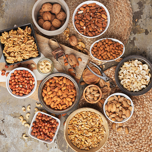 Flat lay of various nuts ranging from almonds and cashew nuts to pecan and Brazilian nuts