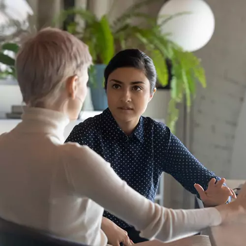 Two woman having a conversation in the office