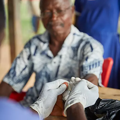 Nurse pricking patient with needle