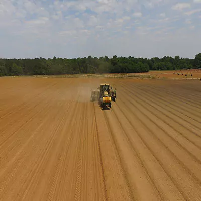 Tractor ploughing an open field