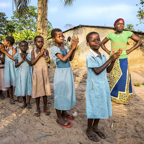 Children clapping hands in a village